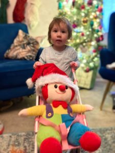Photo of Junior Gymbo in a toy pushchair at Christmas