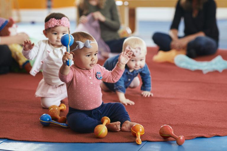 baby shaking maracas